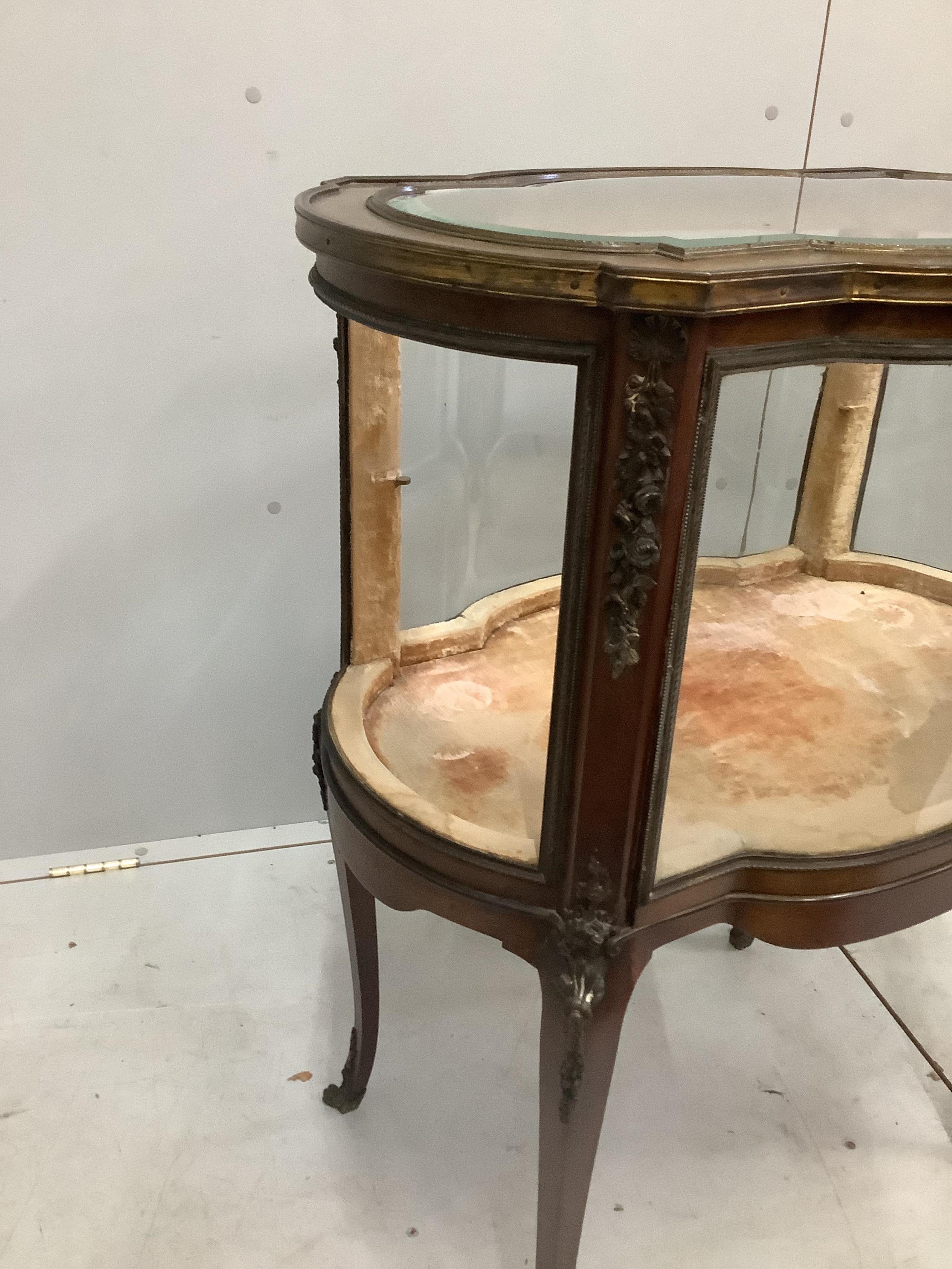 An early 20th century gilt metal mounted mahogany bijouterie cabinet, (one glass panel missing), width 68cm, depth 46cm, height 86cm. Condition - fair